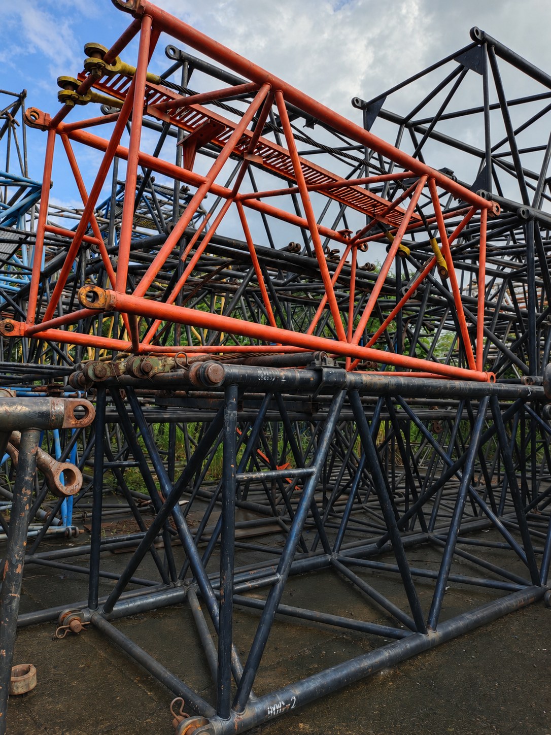 Crane boom sections in an industrial yard